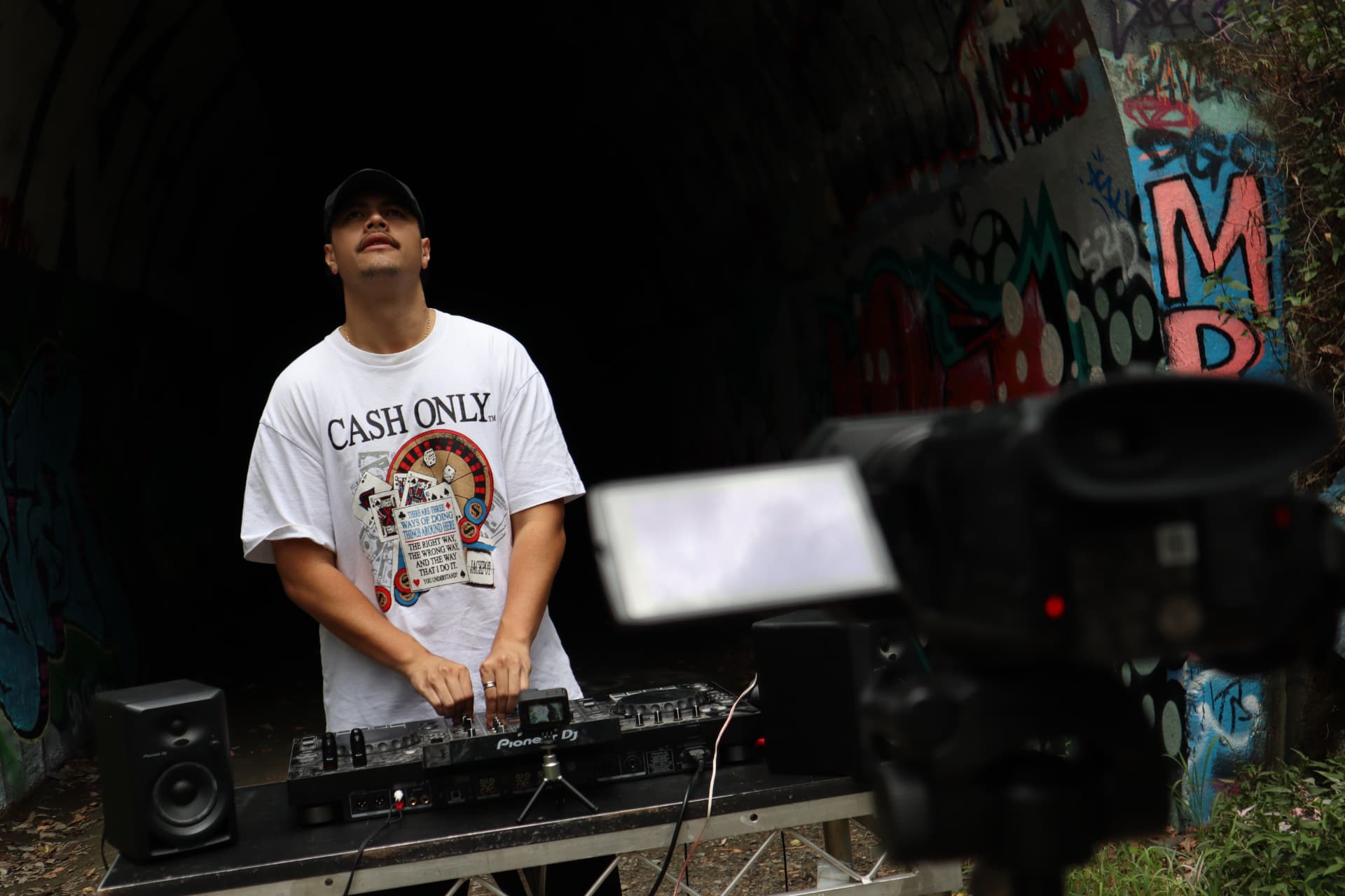 DJ filmed in a graffiti tunnel