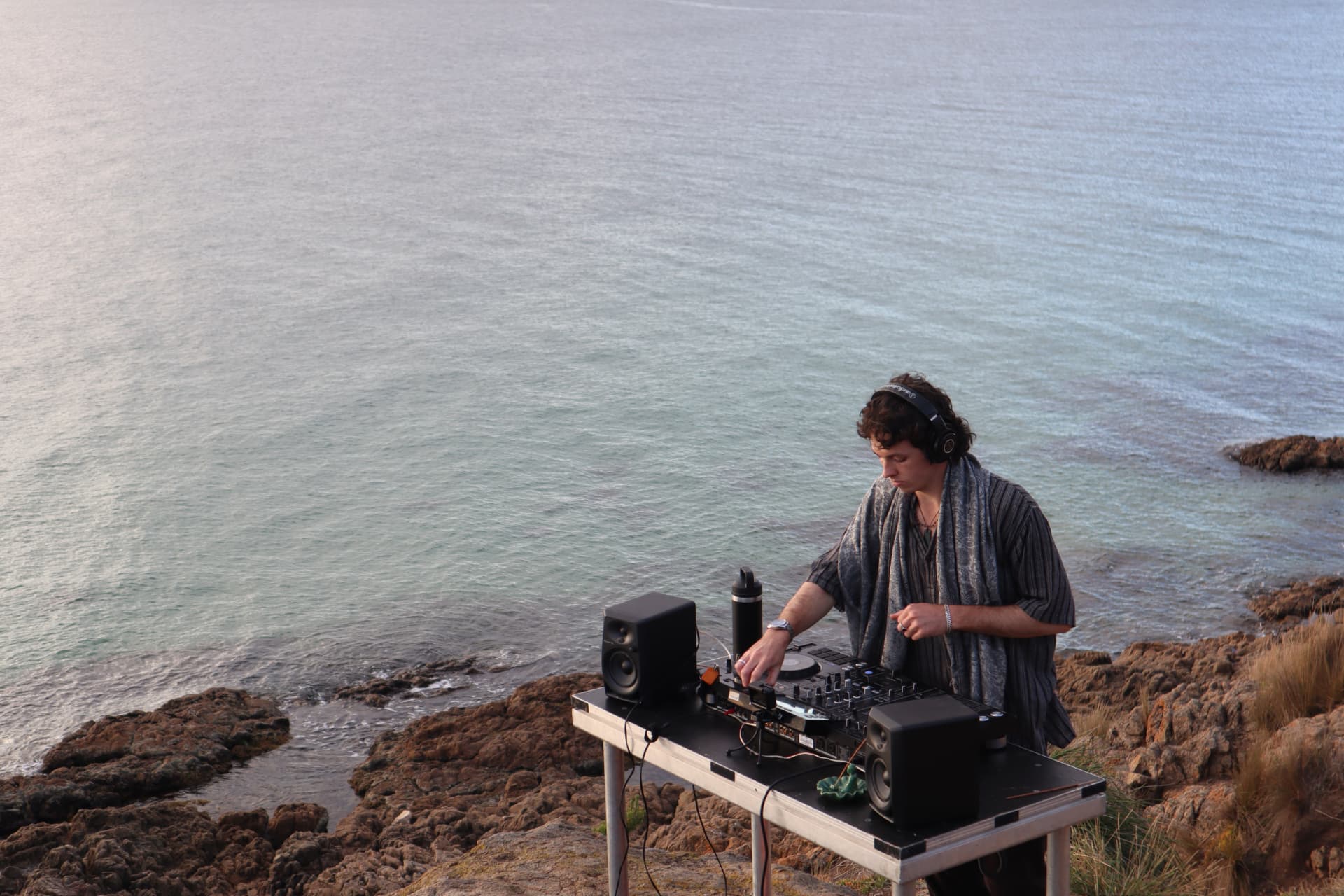DJ set on the coastline at golden hour